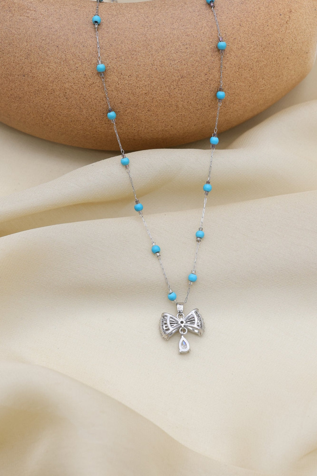 Turquoise Bow Necklace by FSL&CO, gold bow pendant with turquoise accents