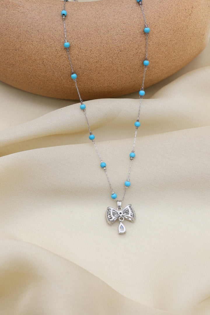 Turquoise Bow Necklace by FSL&CO, gold bow pendant with turquoise accents