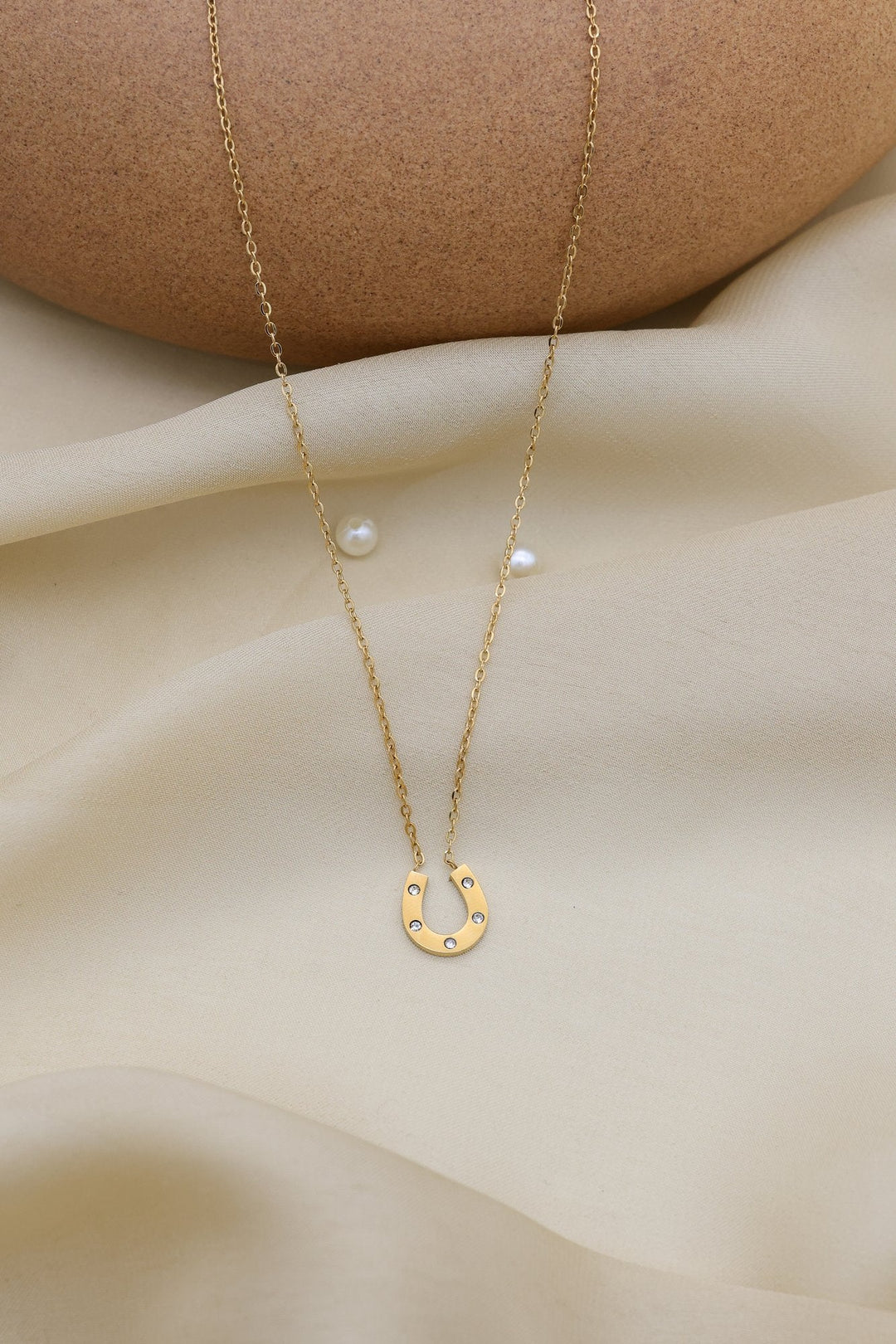 Lucky Horseshoe Necklace by FSL&CO, close-up of the horseshoe pendant