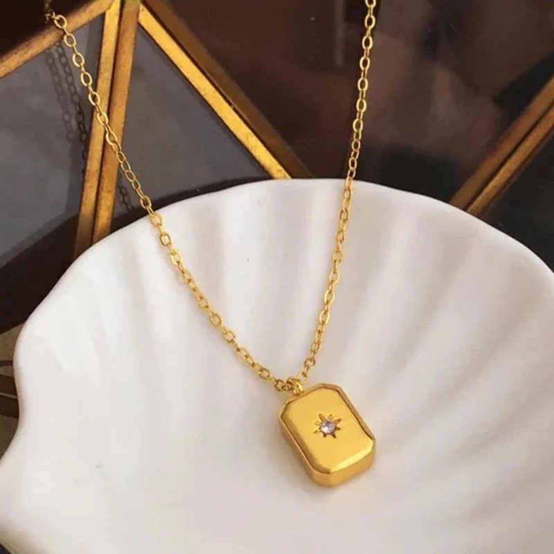Golden Starburst Necklace by FSL&CO, rectangular pendant with engraved starburst