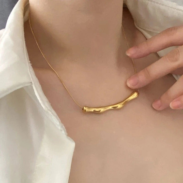 Sculpted Gold Bar Necklace by FSL&CO, curved sculptural gold bar pendant